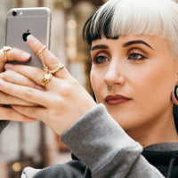 A women wearing wooden ear gauges as the best material for stretching ears