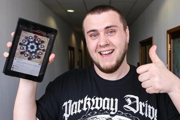 Custom Plugs employee holds up ipad with Custom plugs website