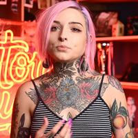 An experienced ear stretcher, who features many tattoos and piercings, speaks about Custom Plugs and how to safely gauge ears.