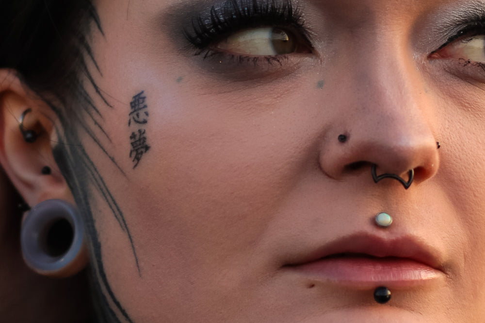 A women showing how a flat backed nose stud is fashionable and comfortable for nose piercings.