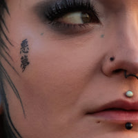 A women showing how a flat backed nose stud is fashionable and comfortable for nose piercings.