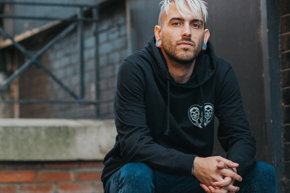 A man showcasing his style by wearing double flare plugs in his stretched ears.