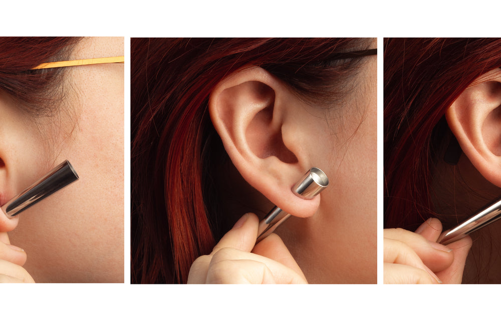 A women showing how to slowly and safely stretch ears using surgical steel tapers.