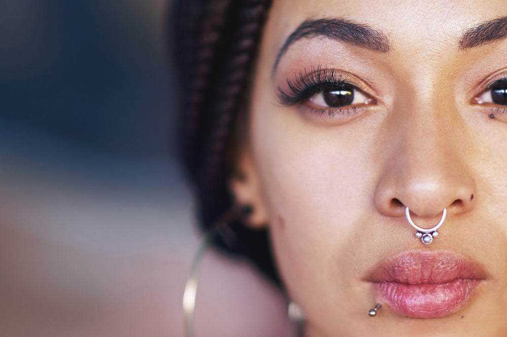 A women showing her fashionable septum ring piercing.