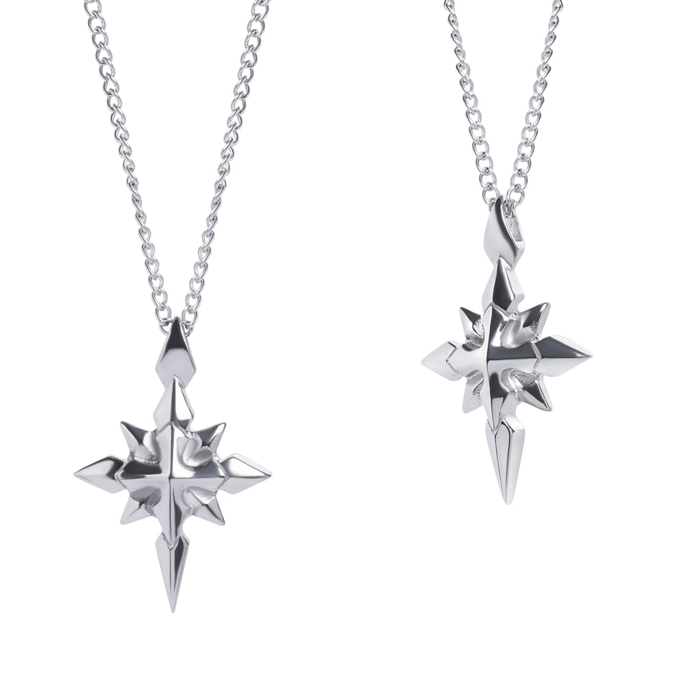 Two silver star-shaped pendants on chains against a white background