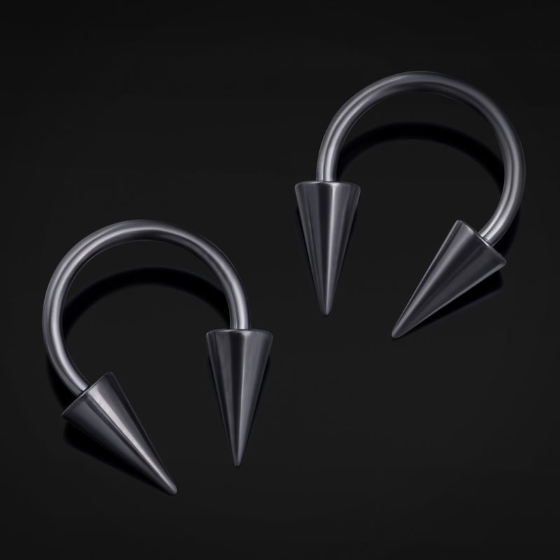 Pair of metallic hoop earrings with spike details on a black background