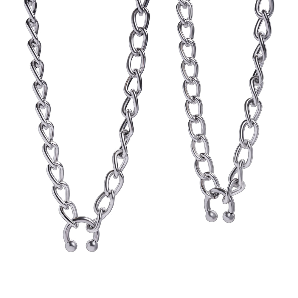 A silver chunky chain necklace with a horseshoe shape design, displayed against a white background.