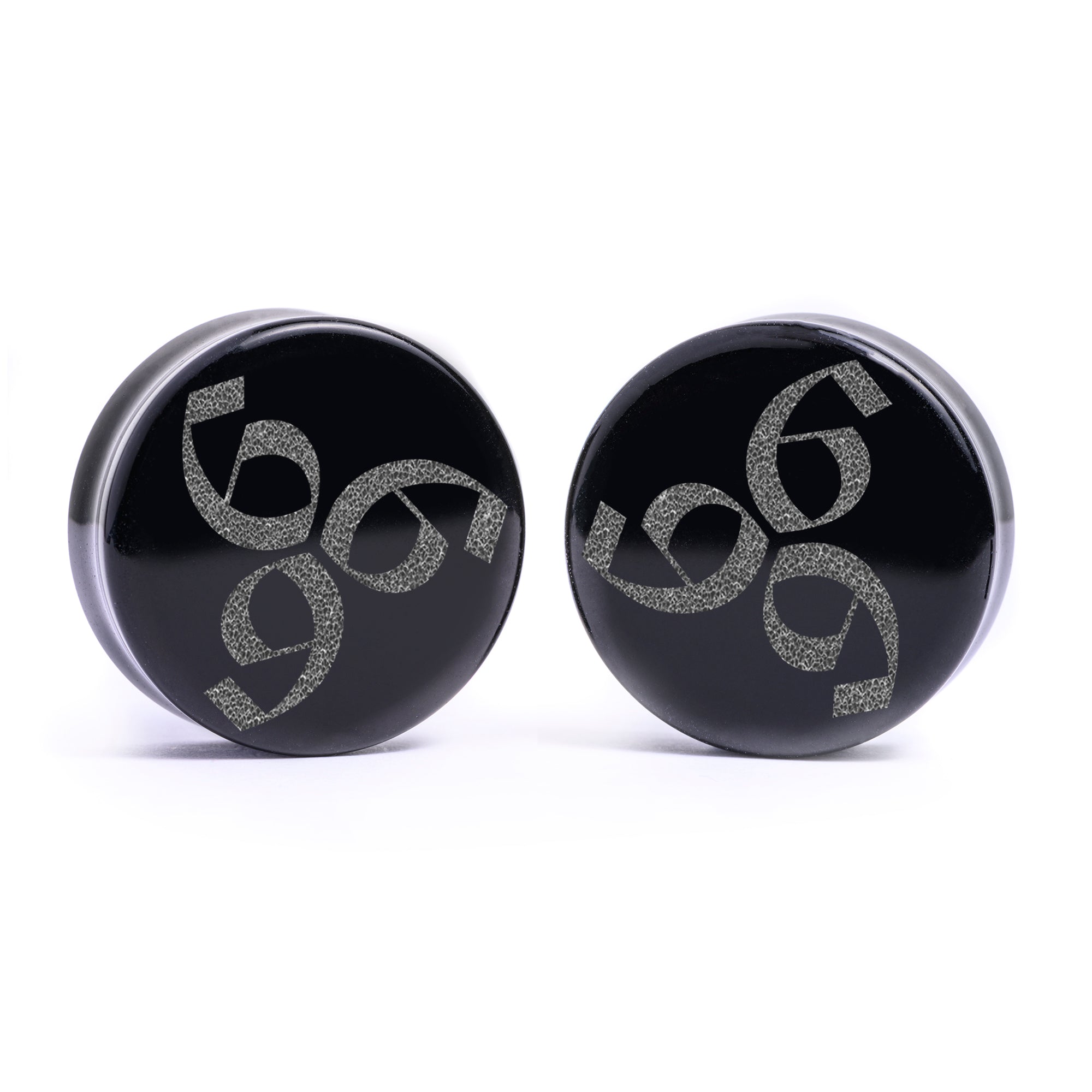 Woman wearing awesome demon face acrylic inlay and wood plugs / gauges