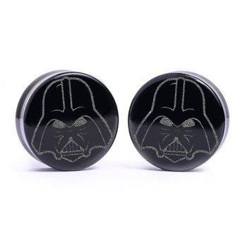 Woman wearing awesome demon face acrylic inlay and wood plugs / gauges