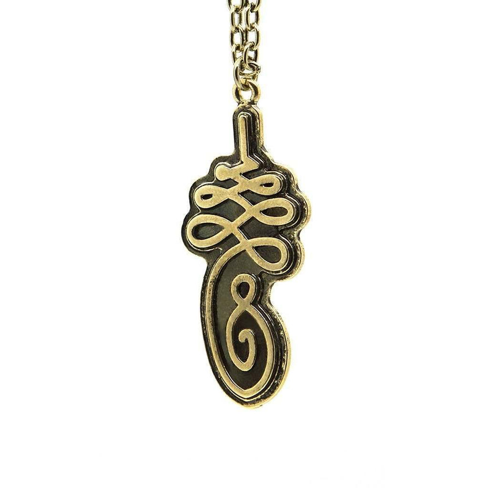 A brass necklace featuring a detailed Unalome symbol pendant attached to a 30cm chain.
